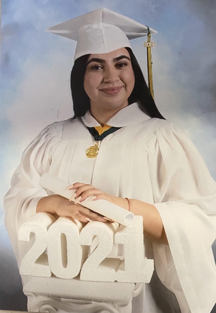 portrait of Student Jahnee in white cap and gown with 2021